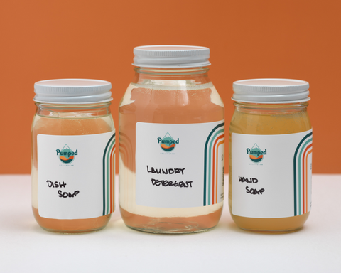Hand soap, Laundry soap, and dish soap in glass mason jars with handwritten labels.